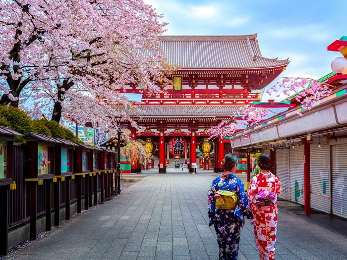 Two,geishas,wearing,traditional,japanese,kimono,among,sensoji,temple,in