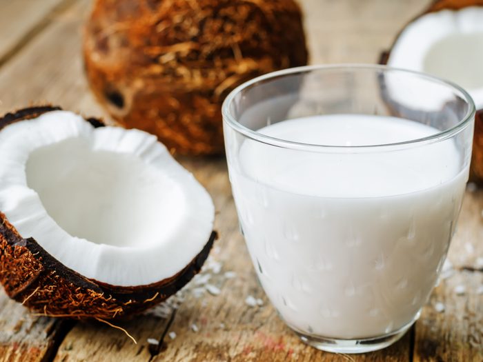 Coconut,milk,and,coconuts,on,a,dark,wood,background.,the