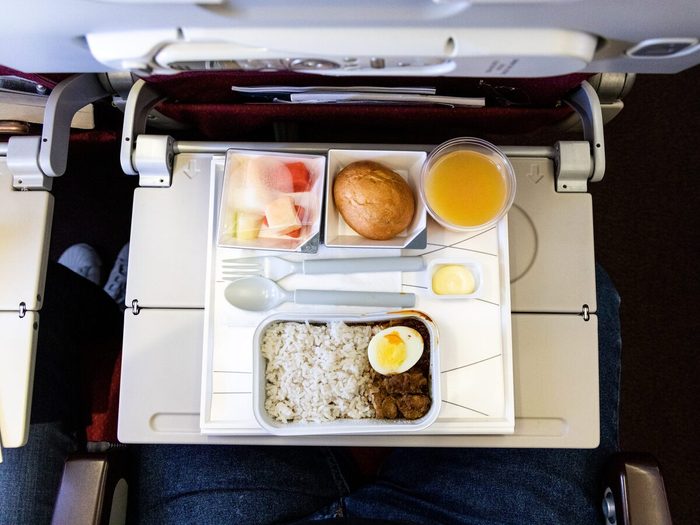 Basic Inflight Meal Consisting Rice, Egg, Beef Curry, Bread, Juice.