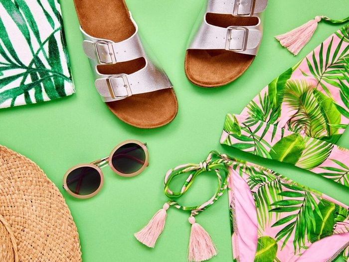 Overhead Shot Of Summer Vacation Accessories On Green Background