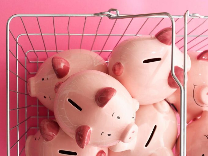 Shopping Cart With Piggy Banks On Pink Background, View From Above