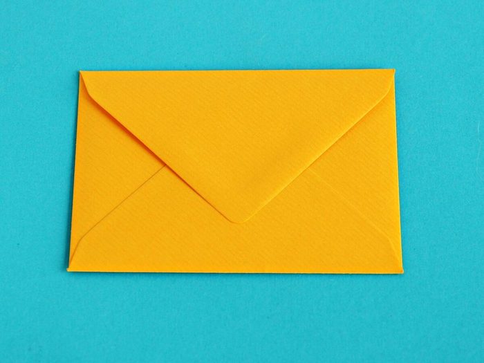 Yellow Envelope Over Turquoise Background