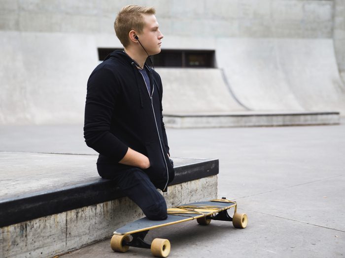 Young,and,motivated,handicapped,guy,with,a,longboard,in,the