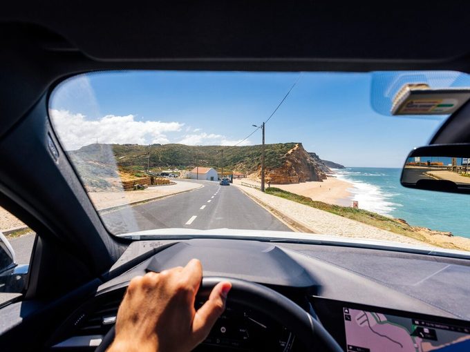 Personal Perspective Point Of View Of A Man Driving Along The Atlantic Coast In Portugal