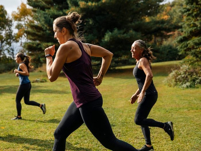 Group Of Women Running Together At Park