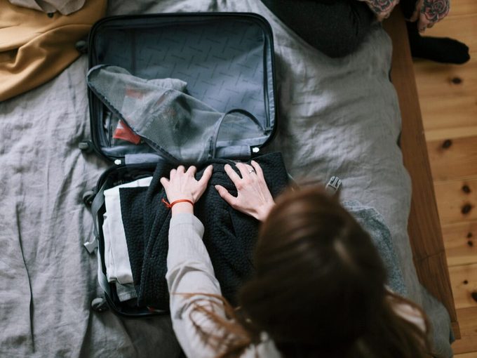 Woman Packing A Suitcase