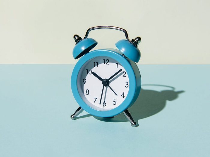 Alarm Clock On A Blue And Beige Background